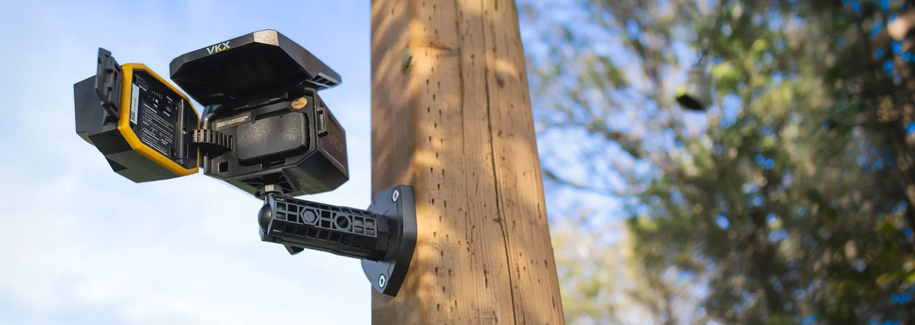 VKX camera open front-access panel mounted on a wooden post